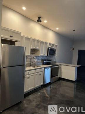 Littleton apartment for rent - A modern kitchen with stainless steel appliances and white cabinets.