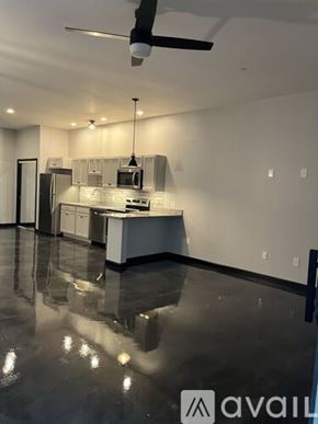 Littleton apartment for rent - A modern kitchen with a black floor and white walls.
