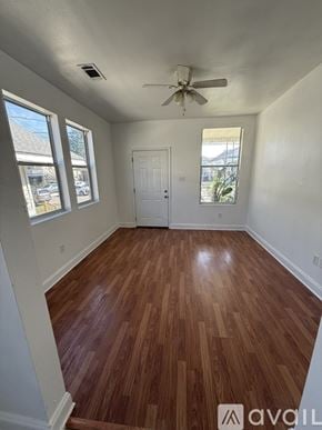 New Orleans apartment for rent - A room with wooden flooring and white walls.