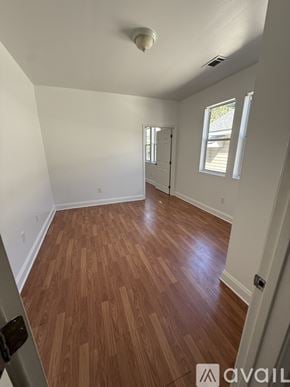 New Orleans apartment for rent - A room with wooden flooring and a ceiling fan.