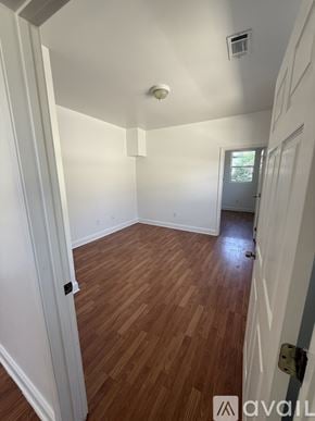 New Orleans apartment for rent - A room with a wooden floor and a ceiling fan.