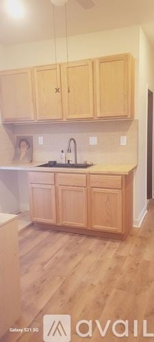 Chicago apartment for rent - A kitchen with wooden cabinets and a white countertop.