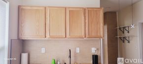 Chicago apartment for rent - A kitchen with wooden cabinets and a white fridge.