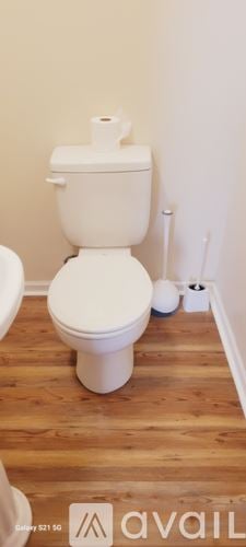 Chicago apartment for rent - A white toilet with a roll of toilet paper on top.