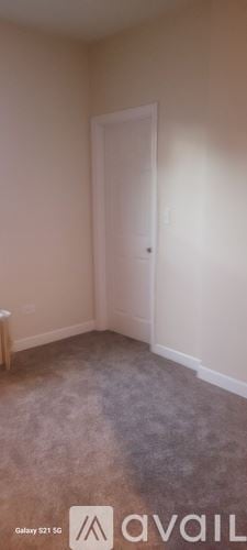 Chicago apartment for rent - A room with a carpeted floor and a door.