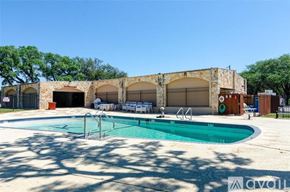 Lago Vista house for rent - A pool area with a stone building and chairs.