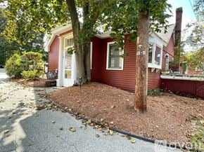 Chelmsford condo for rent - A red house with a tree in front of it.
