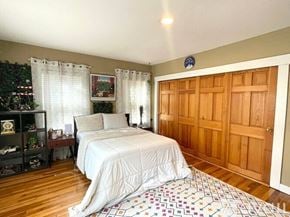 Chelmsford condo for rent - A bedroom with a large bed and a Christmas tree in the corner.