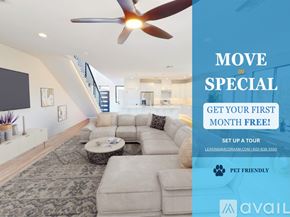 Phoenix house for rent - A living room with a large fan and a sign offering a free first month for a move-in special.