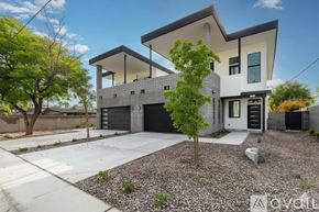 Phoenix house for rent - A modern two-story house with a garage and a tree in front.