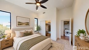 Phoenix house for rent - A bedroom with a large bed and a ceiling fan.