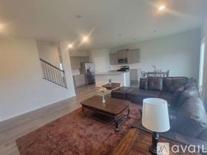 Granville house for rent - A bedroom with a large bed and a painting on the wall.