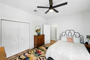 San Antonio house for rent - A bedroom with a bed, dresser, and ceiling fan.