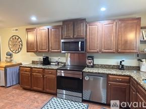 Mount Pleasant house for rent - A kitchen with wooden cabinets and a stainless steel oven.