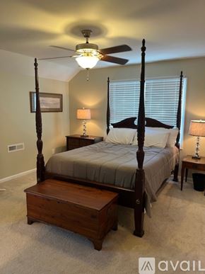 Mount Pleasant house for rent - A bedroom with a four poster bed and a ceiling fan.