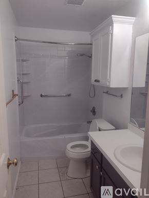 Yukon house for rent - A white bathroom with a toilet, sink, and bathtub.