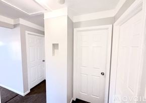 Warren house for rent - A hallway with three white doors.