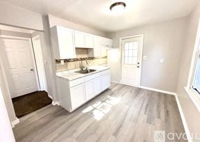 Warren house for rent - A kitchen with white cabinets and a sink.