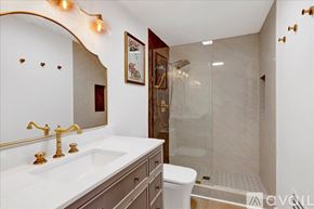 Homewood condo for rent - A bathroom with a white sink and gold fixtures.