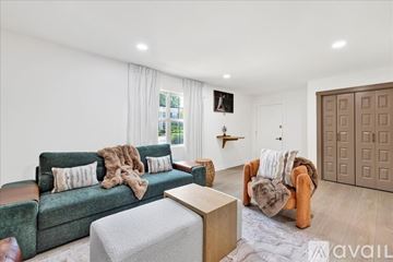 Homewood condo for rent - A living room with a green couch and a brown armchair.