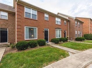Lexington house for rent - A row of red brick houses with green lawns in front.