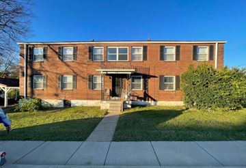 Louisville apartment for rent - A red brick building with a balcony on the second floor.