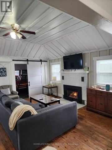Chatham-Kent (Blenheim) house for rent - A living room with a grey couch and a fireplace.