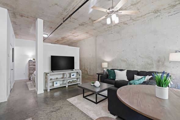 Atlanta apartment for rent - A living room with a black couch and a television on a white stand.