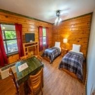 Buchanan apartment for rent - A room with two beds and a table with chairs.