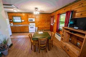 Buchanan apartment for rent - A wooden cabin with a table and chairs in the middle of the room.