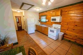 Buchanan apartment for rent - A kitchen with wooden walls and a white fridge.