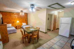 Buchanan apartment for rent - A room with a wooden wall and a table with chairs.