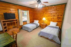 Buchanan apartment for rent - A room with two beds, a table, and a television.