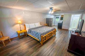 Buchanan apartment for rent - A bedroom with a bed, chair, and lamp.
