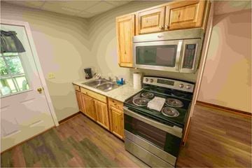 Buchanan apartment for rent - A kitchen with a stove top oven and microwave above it.