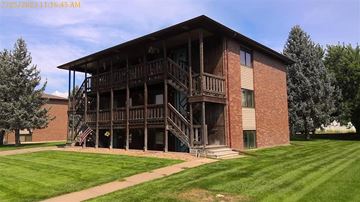 Kearney apartment for rent - A large brick building with a balcony and a flag on it.