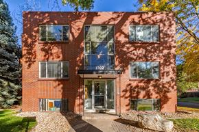 Denver apartment for rent - A red brick building with the number 1302 on the front.