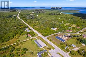 Northern Bruce Peninsula townhouse for rent - An aerial view of a residential area with Escarpment Heights and Sutton Sound Realty Brokerage.