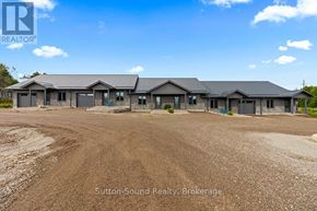Northern Bruce Peninsula townhouse for rent - A real estate brokerage office with a dirt road in front.