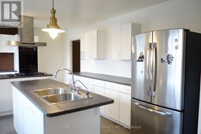 Richmond Hill house for rent - A modern kitchen with a stainless steel refrigerator and a double sink.