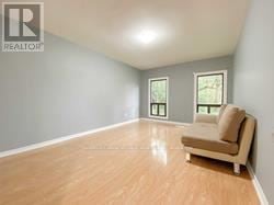Richmond Hill house for rent - A living room with a couch and a window.