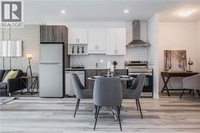 Kitchener condo for rent - A modern kitchen with a dining table set for four.