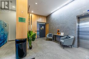 Oshawa (O'neill) condo for rent - A brokerage office with a blue trash can and a plant in a black pot.