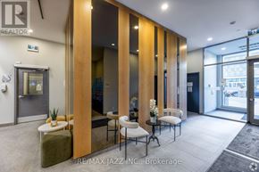 Oshawa (O'neill) condo for rent - A modern office lobby with a glass wall and a reception desk.