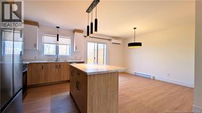 Shediac house for rent - A kitchen with wooden cabinets and a countertop is shown.
