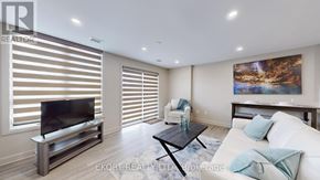 Belleville (Thurlow Ward) house for rent - A modern living room with a flat screen TV and a coffee table.