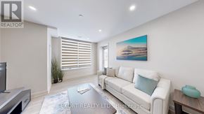 Belleville (Thurlow Ward) house for rent - A living room with a white couch and a painting on the wall.