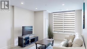 Belleville (Thurlow Ward) house for rent - A living room with a flat screen TV and a couch.