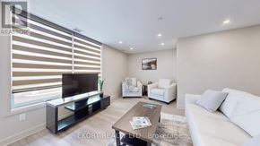 Belleville (Thurlow Ward) house for rent - A modern living room with a flat screen TV and a coffee table.