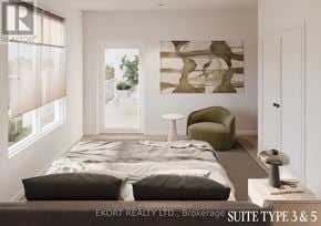 Belleville (Thurlow Ward) house for rent - A bedroom with a bed, a green chair, and a painting on the wall.